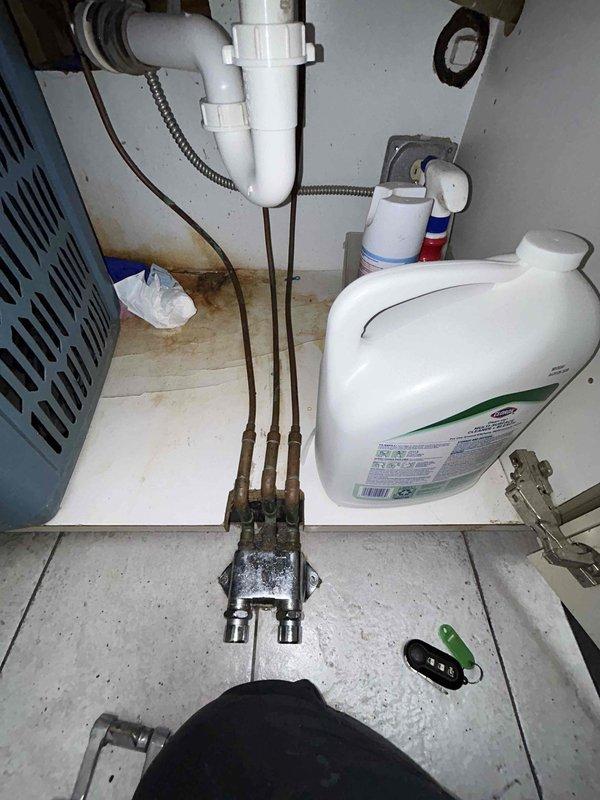 Responded to water leak complaint at sink in sterilization room. Inspected foot pedal assembly and confirmed intermittent leak caused by broken foot pedal mechanism. Documented existing plumbing configuration including P-trap assembly, supply lines, and manifold connections beneath sink. Part will be staged in warehouse for subsequent installation to resolve leak issue.