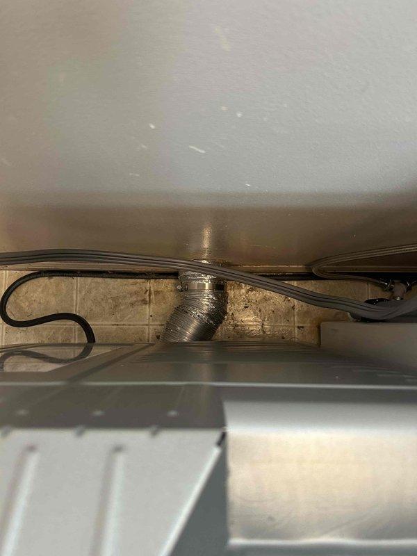 Performed comprehensive dryer vent cleaning on an estimated 20-30 year old vent system that had never been previously serviced. Inspection revealed significant accumulation of lint, dust, and debris throughout the ductwork, particularly concentrated at the terminal opening and along the bottom of the flexible aluminum vent line running through the crawlspace. Removed all buildup using professional rotary brush system and high-powered vacuum equipment to restore proper airflow and eliminate fire hazard associated with restricted venting.