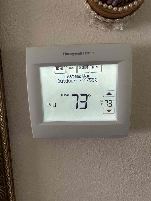 Responded to service call for ongoing system performance concerns and high indoor humidity complaints since 2020 installation. Upon arrival, verified thermostat settings and observed indoor temperature at 73°F with humidity reading at 53%, while outdoor conditions measured 78°F at 51% humidity. System was in wait mode during inspection, indicating normal cycle operation. Documented current environmental conditions using both thermostat display and independent weather monitoring equipment to establish baseline readings for humidity concerns. Advised customer on typical humidity levels and system performance parameters, confirming equipment is maintaining setpoint temperature as programmed.