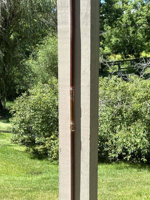 Responded to service call for burst copper water line mounted vertically on exterior deck post. The line, which supplied a hose connection for cleaning the second-level deck, had frozen and ruptured during winter months. Upon arrival, water supply was confirmed off and damage was assessed. Documented existing installation showing copper pipe secured to deck post with mounting brackets. Discussed freeze protection options with property owner including pipe insulation, heat tape application, and installation of frost-free hose bib with proper drainage slope. Photographed damaged copper line and mounting configuration for replacement planning and future reference.