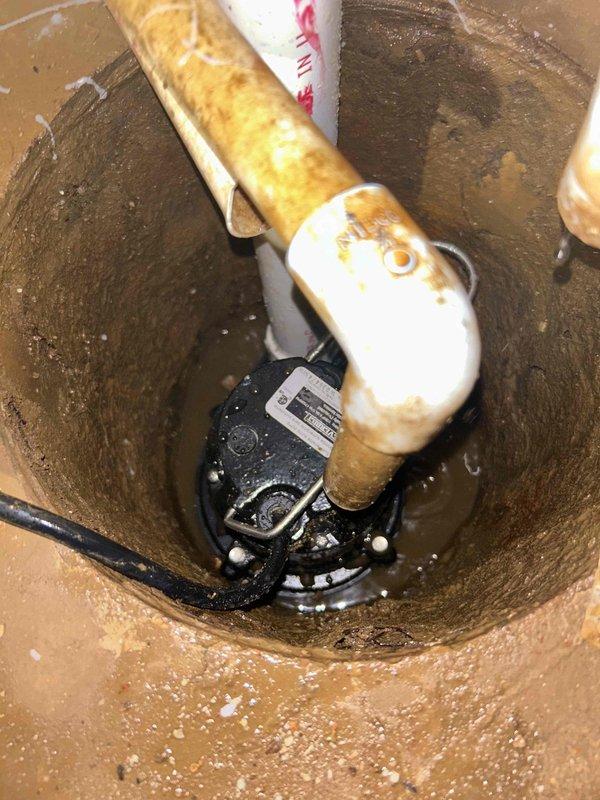 Removed deteriorated sump pump system from existing basin and installed new submersible sump pump unit. The previous pump showed significant wear and corrosion, with mineral buildup evident throughout the basin and discharge piping. Completed full system replacement to restore proper groundwater drainage and basement protection functionality.