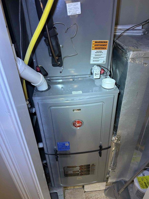 Responded to no cooling complaint on 2-year-old Rheem air conditioning system. Upon arrival, confirmed outdoor condenser fan was not operating while compressor attempted to run. Diagnosed failed condenser fan motor due to electrical failure. Replaced defective fan motor with OEM replacement part, verified proper rotation and amperage draw. Tested system operation through complete cooling cycle, confirmed adequate airflow across condenser coil and proper temperature split at indoor unit. System restored to normal cooling operation.