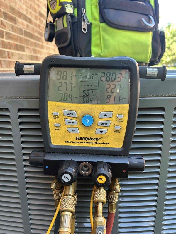 Responded to service callback for non-cooling system with intermittent outdoor fan operation. Customer had replaced filter as previously recommended, but unit continued to short-cycle with condenser fan running only briefly before shutting down. Performed diagnostic testing using refrigerant manifold and digital gauges, measuring system pressures and temperatures to identify compressor or electrical failure causing the repeated cycling issue.