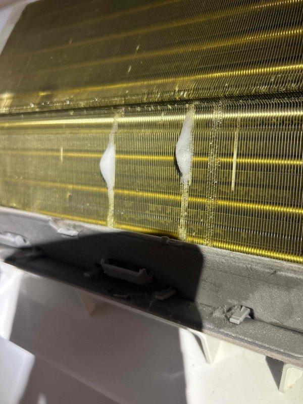 Performed ultrasonic leak search on HVAC system with specific focus on lineset as suspected leak source. Upon inspection, evaporator coil showed significant contamination with dust accumulation, discoloration, and localized frost/ice buildup indicating active refrigerant leak and compromised heat transfer efficiency. Documented coil condition showing uneven frost patterns and debris accumulation on fins, confirming need for leak repair and system servicing.