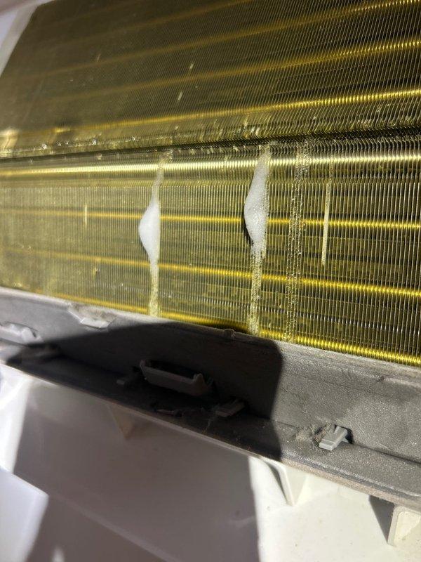 Performed ultrasonic leak search on HVAC system with specific focus on lineset as suspected leak source. Upon inspection, evaporator coil showed significant contamination with dust accumulation, discoloration, and localized frost/ice buildup indicating active refrigerant leak and compromised heat transfer efficiency. Documented coil condition showing uneven frost patterns and debris accumulation on fins, confirming need for leak repair and system servicing.