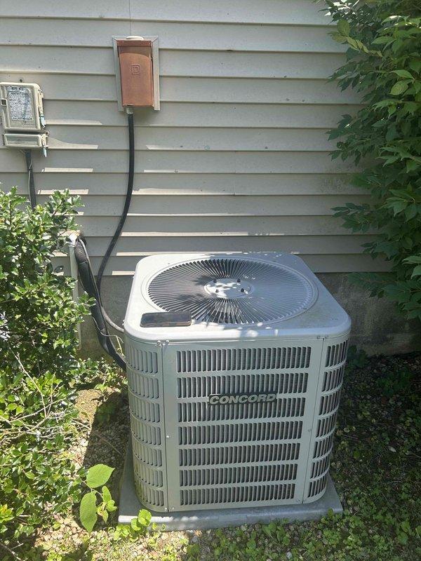 Responded to no cooling complaint on aging Concord split system with gas furnace and attic-mounted air handler. System had previously frozen and was now running continuously with insufficient cooling capacity. Performed diagnostic evaluation of outdoor condensing unit and measured ductwork dimensions at indoor unit location. Documented equipment condition and installation configuration for assessment of system performance issues related to continuous operation and inadequate temperature control.