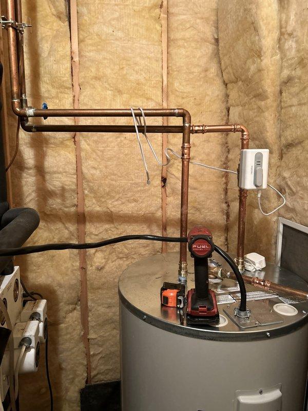 Installed two 50-gallon Bradford White electric water heaters in parallel configuration in utility room with exposed stud walls. Completed all necessary plumbing connections using copper pipe and PEX tubing with brass fittings, installed three safety shut-off valves for system isolation and emergency protection, and connected electrical supply via conduit to junction box. Verified proper operation of both units and ensured all connections met code requirements.
