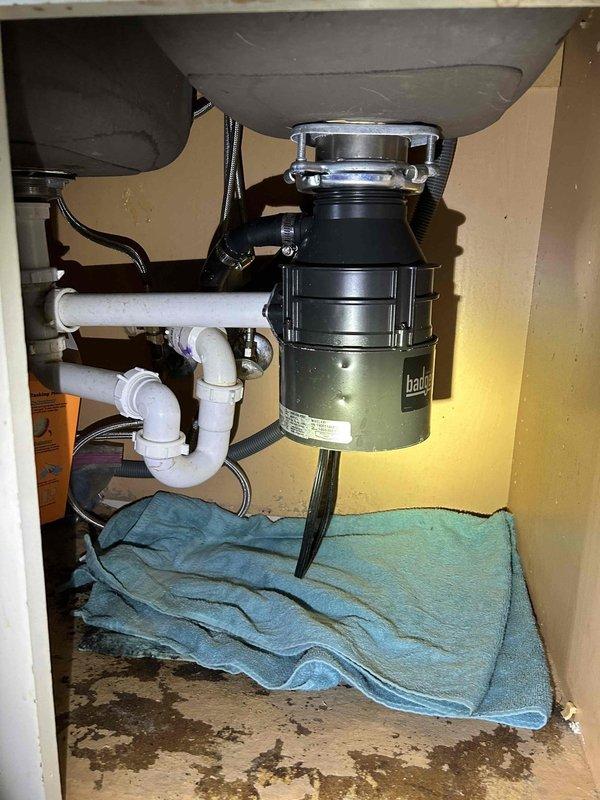 Completed routine plumbing maintenance inspection of residential property. Inspected under-sink plumbing including garbage disposal unit, P-trap configuration, and PVC drainage system, confirming all components are properly connected and functioning without visible leaks. Examined water heater unit, supply lines, shut-off valves, and pressure relief valve assembly, verifying all connections are secure and system is operating within normal parameters.