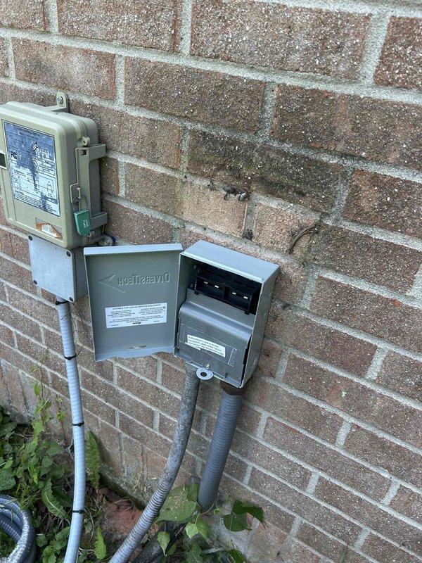 Responded to a no cooling call on a heat pump system serving the sanctuary that had been tripping the breaker for approximately three weeks. Upon arrival, performed diagnostic evaluation of the outdoor unit and electrical components. Inspected the contactor assembly and found significant dirt, debris, and oxidation on terminals and connection points, indicating age and environmental exposure. Examined the electrical disconnect box and meter installation mounted on exterior brick wall. Assessed internal wiring connections, terminal blocks, and contactor housing which showed wear consistent with extended service life. Documented existing conditions of electrical components including accumulated dust, cobwebs, and surface corrosion on brass terminals. System evaluation revealed compromised electrical connections and deteriorated contactor assembly as likely causes of breaker trips. Provided customer with findings and repair recommendations to restore proper cooling operation and prevent c