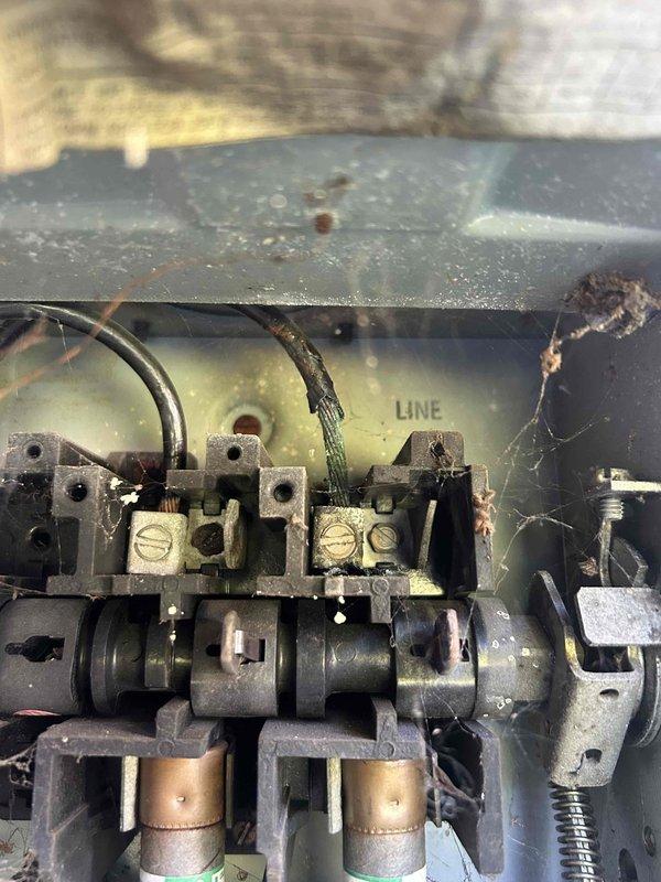 Responded to a no cooling call on a heat pump system serving the sanctuary that had been tripping the breaker for approximately three weeks. Upon arrival, performed diagnostic evaluation of the outdoor unit and electrical components. Inspected the contactor assembly and found significant dirt, debris, and oxidation on terminals and connection points, indicating age and environmental exposure. Examined the electrical disconnect box and meter installation mounted on exterior brick wall. Assessed internal wiring connections, terminal blocks, and contactor housing which showed wear consistent with extended service life. Documented existing conditions of electrical components including accumulated dust, cobwebs, and surface corrosion on brass terminals. System evaluation revealed compromised electrical connections and deteriorated contactor assembly as likely causes of breaker trips. Provided customer with findings and repair recommendations to restore proper cooling operation and prevent c