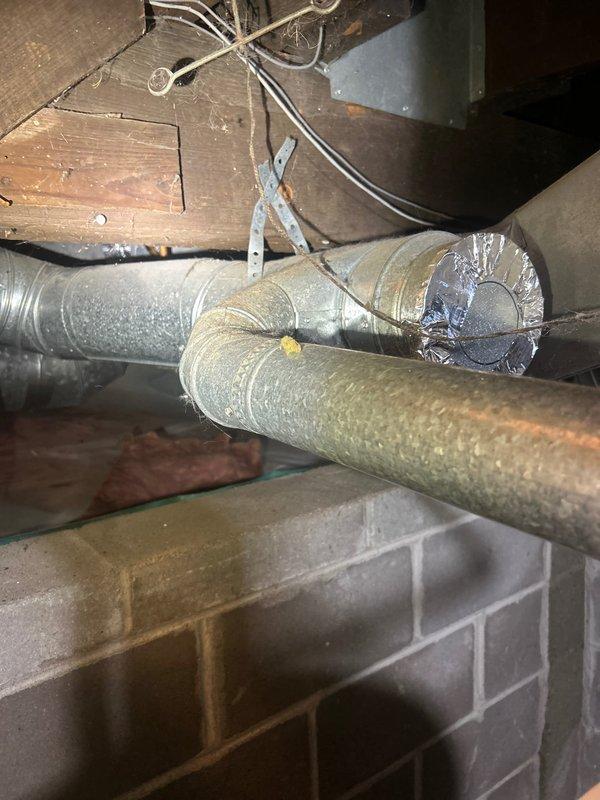 Responded to non-urgent service call for non-operational air conditioning system in guest house. Conducted thorough diagnostic inspection of HVAC system including examination of ductwork infrastructure in crawl space and basement utility area. Documented existing conditions of insulated duct runs, metallic tape seals, support brackets, and overall system components to assess potential causes of AC malfunction and determine necessary repairs.