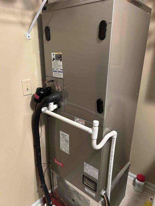 Responded to callback for AC unit leaking water onto floor. Upon inspection, found condensate drain pan showing signs of standing water and staining, with evaporator coil displaying dirt accumulation on fins. Documented air handler interior condition and drainage system components with photos for service records.