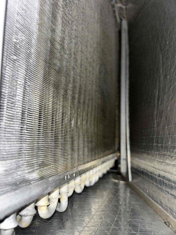 Responded to callback for AC unit leaking water onto floor. Upon inspection, found condensate drain pan showing signs of standing water and staining, with evaporator coil displaying dirt accumulation on fins. Documented air handler interior condition and drainage system components with photos for service records.