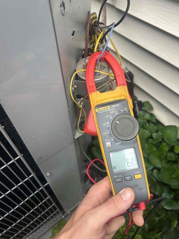 Completed Club Green preventive maintenance tune-up on gas furnace/heat pump system located in attic. Performed comprehensive electrical diagnostics on outdoor unit using professional-grade clamp meter, verifying amperage draw and voltage readings to ensure proper system operation. All electrical connections at outdoor disconnect inspected and found secure. System operating within manufacturer specifications with measured amperage at 6.6A and voltage reading of 38.76V recorded during testing. Customer to provide air filters as previously arranged.