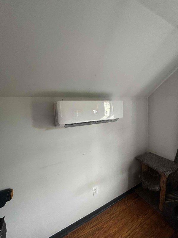 Completed full installation of a Friedrich 2-ton dual-head mini-split system. Mounted two indoor air handler units in upper-level rooms with sloped ceilings, positioning units on interior walls with proper clearances for optimal airflow distribution. Installed outdoor condensing unit on exterior brick wall using heavy-duty wall mounting bracket to ensure secure attachment and proper elevation above grade.

Ran new communication line set and refrigerant lines from both indoor heads through wall penetrations to outdoor unit location, ensuring proper insulation and protection of all refrigerant piping. Installed new electrical wiring from indoor units to outdoor condensing unit, routing conductors through liquid-tight flexible conduit for weather protection. Made all electrical terminations at outdoor disconnect box, connecting line voltage conductors to terminal blocks with proper torque specifications. Verified all wire connections were secure and met code requirements.

Performed vacuu