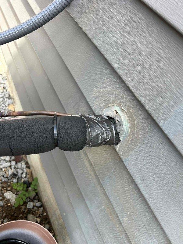 Responded to warranty call for damaged refrigerant line insulation on heat pump system. Upon arrival, inspected exterior installation and confirmed that foam insulation sleeve on refrigerant lines had partially deteriorated and separated from piping. Replaced damaged black foam insulation on exposed refrigerant lines, ensuring proper coverage and secure fit. Verified all pipe penetrations through building siding were properly sealed and weatherproofed. System inspected and confirmed operational with no refrigerant leaks detected.