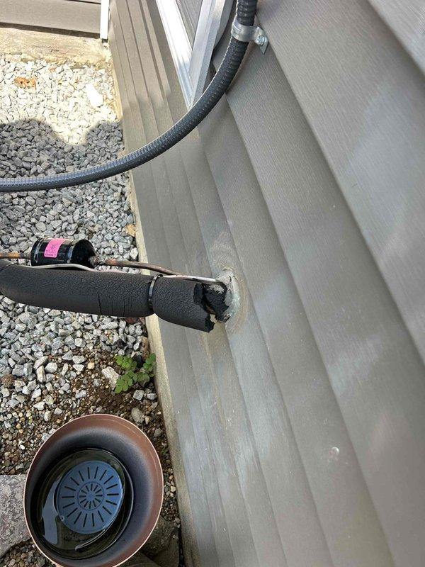 Responded to warranty call for damaged refrigerant line insulation on heat pump system. Upon arrival, inspected exterior installation and confirmed that foam insulation sleeve on refrigerant lines had partially deteriorated and separated from piping. Replaced damaged black foam insulation on exposed refrigerant lines, ensuring proper coverage and secure fit. Verified all pipe penetrations through building siding were properly sealed and weatherproofed. System inspected and confirmed operational with no refrigerant leaks detected.
