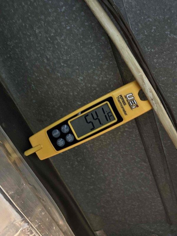 Responded to a no cooling complaint on a 19-year-old gas electric air conditioning system. Upon inspection, discovered the outdoor unit capacitor had failed, preventing the compressor and condenser fan from operating properly. Measured supply temperature at 54 degrees, confirming inadequate cooling performance. Replaced the defective dual-run capacitor with a new MARS 10µF 370VAC capacitor, restored power to the unit, and verified proper system operation with normal compressor and fan motor function.