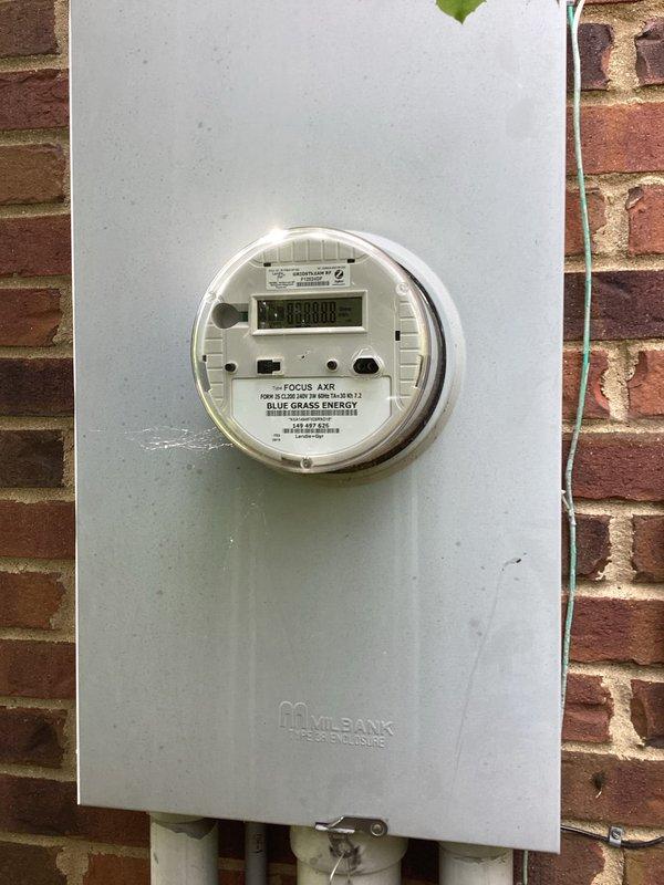 Completed electrical site assessment for propane-powered backup generator installation at residential property. Evaluated existing electrical service panel and meter configuration, documented current Milbank meter base with Blue Grass Energy metering equipment mounted on brick exterior, and assessed propane gas meter location and proximity to proposed generator placement. Identified circuit breaker panel capacity requirements and determined necessary electrical infrastructure modifications to accommodate automatic transfer switch and generator connection. Provided comprehensive estimate for complete generator installation including dedicated propane fuel line integration, proper electrical disconnects, and required circuit breaker upgrades to support backup power system.