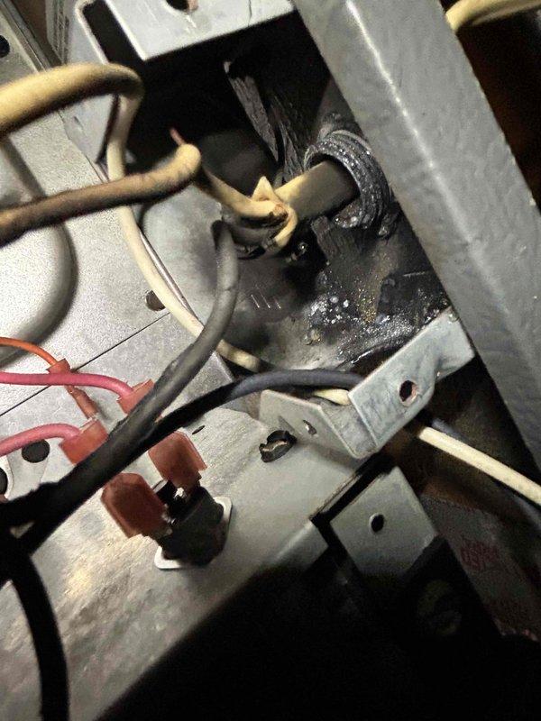 Responded to no cooling call on 20-year-old air conditioning system. Upon inspection, discovered severe electrical failure with significant burn damage and charring at wire connection point in outdoor unit's control panel. Supply air temperature measured at 67.2°F, confirming complete loss of cooling capacity. Due to age of equipment and extent of electrical damage, recommended system replacement. Customer expressed interest in enrolling in maintenance service plan during visit.