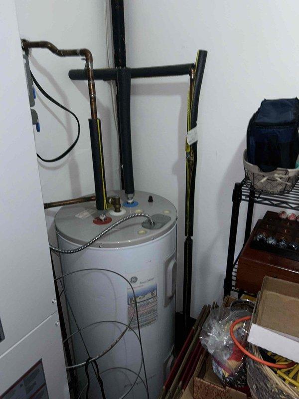 Conducted plumbing estimate for water heater replacement in residential storage room. Inspected existing tank-style water heater, approximately 50-gallon capacity, with standard top-mounted connections including hot and cold water supply lines, temperature and pressure relief valve, and gas supply piping. Documented current installation configuration including copper supply piping, black iron gas lines, flexible gas connector, and earthquake restraint straps. Assessed clearance requirements, venting system accessibility, and utility connections to provide accurate replacement specifications and material requirements for future water heater installation.