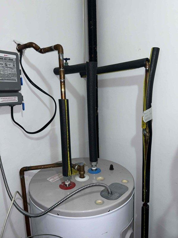 Conducted plumbing estimate for water heater replacement in residential storage room. Inspected existing tank-style water heater, approximately 50-gallon capacity, with standard top-mounted connections including hot and cold water supply lines, temperature and pressure relief valve, and gas supply piping. Documented current installation configuration including copper supply piping, black iron gas lines, flexible gas connector, and earthquake restraint straps. Assessed clearance requirements, venting system accessibility, and utility connections to provide accurate replacement specifications and material requirements for future water heater installation.