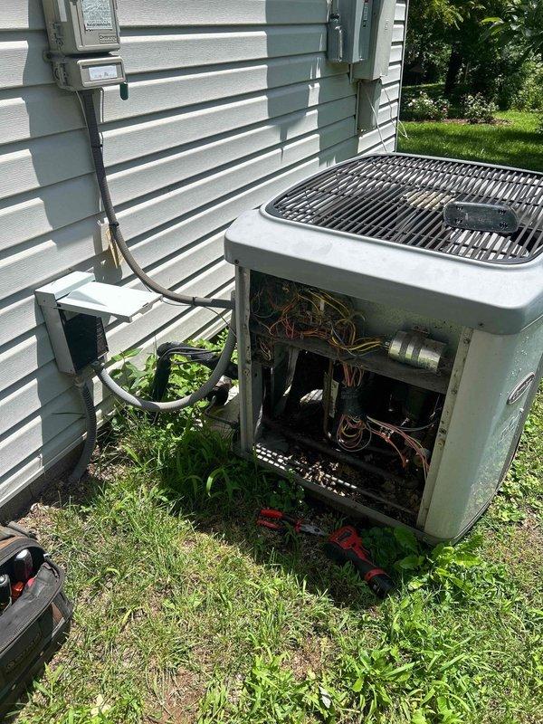 Responded to service call for 20-year-old heat pump system with complete loss of cooling affecting entire home. Performed comprehensive system evaluation of outdoor condensing unit and indoor air handler components. Inspected aging equipment including compressor, refrigerant lines, electrical connections, and ductwork system in attic space. Documented current system configuration with exterior unit positioned on ground-level pad and flexible duct distribution throughout conditioned space. Due to advanced age of equipment and complete system failure, provided detailed replacement estimate for new heat pump installation to restore climate control functionality.