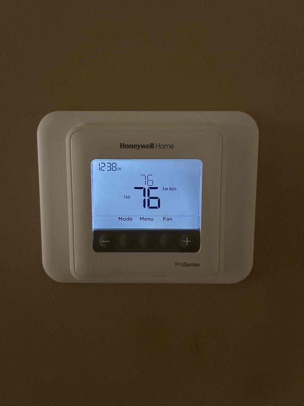 Completed preventative maintenance service on residential air conditioning and gas furnace system located in basement. Inspected thermostat operation and confirmed proper temperature display and cooling mode functionality. Examined outdoor condensing unit and verified dual-run capacitor specifications (70+10 MFD, 440V) with proper labeling and secure mounting. System operating within normal parameters at time of service. Customer to supply air filter (24.5"x27"x5") for future maintenance intervals.