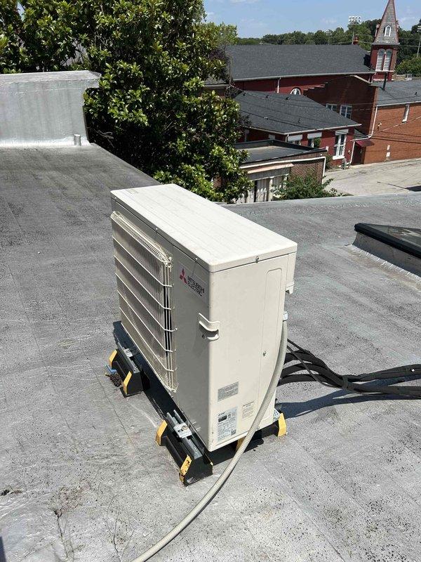 Responded to no cooling complaint on dual Mitsubishi mini-split system with indoor units located in attic. Performed diagnostic evaluation of both outdoor condensing units and indoor air handlers. Inspected refrigerant lines, electrical connections, and control wiring at exterior units mounted on rooftop and at brick wall location. Verified power supply to both systems and checked condensate drainage. Assessed overall system operation and identified necessary repairs to restore cooling function to both zones.