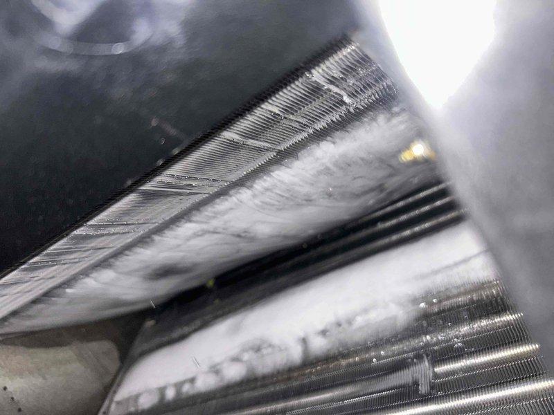 Responded to service call for newly installed AC system experiencing poor cooling and weak airflow throughout home. Upon inspection, discovered severe frost and ice buildup on evaporator coil, indicating restricted airflow or refrigerant issue. Documented frozen coil condition and examined electrical connections at terminal block. Identified improper wiring configuration on five-point terminal connector that was affecting system operation. Corrected wiring connections per manufacturer specifications to resolve cooling deficiency and restore proper airflow to residence.