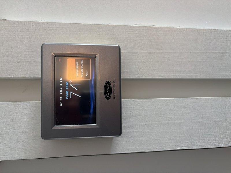 Responded to no cooling call on Carrier Infinity system. Upon arrival, found Carrier Infinity Touch thermostat displaying "OUTDOOR UNIT COMMUNICATION FAULT" error with multiple communication failure alerts logged in system events. Verified power to indoor unit and confirmed breaker was in proper position. Diagnosed communication failure between indoor air handler and outdoor condensing unit, indicating wiring issue, control board failure, or outdoor unit malfunction requiring further troubleshooting of communication bus and outdoor unit components.