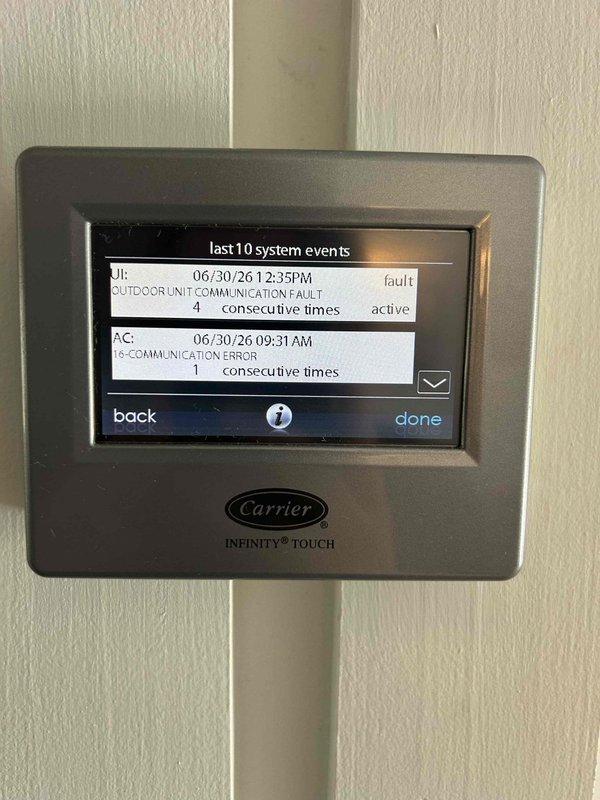 Responded to no cooling call on Carrier Infinity system. Upon arrival, found Carrier Infinity Touch thermostat displaying "OUTDOOR UNIT COMMUNICATION FAULT" error with multiple communication failure alerts logged in system events. Verified power to indoor unit and confirmed breaker was in proper position. Diagnosed communication failure between indoor air handler and outdoor condensing unit, indicating wiring issue, control board failure, or outdoor unit malfunction requiring further troubleshooting of communication bus and outdoor unit components.