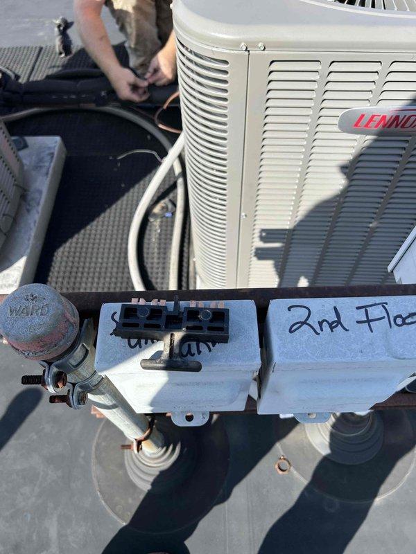 Completed full residential HVAC system replacement including Lennox 2-stage 17 SEER2 2-ton air conditioner (model MLKC1-024-045) and variable speed furnace (model ML296UH045XV36B) with evaporator coil (model K40CT-36B-71). Utilized crane to position outdoor condenser unit on apartment complex rooftop due to elevated installation requirements. Installed new outdoor unit pad, electrical disconnect box, electrical whip kit, and insulated refrigerant lines with filter drier. Configured PVC condensate drain piping with SS2 coil drain safety water sensor for overflow protection. Installed transition from evaporator coil to existing ductwork and new programmable thermostat for system control. Secured all applicable permits, removed and disposed of existing equipment per regulations, and tested all system operations to verify proper functionality and code compliance.