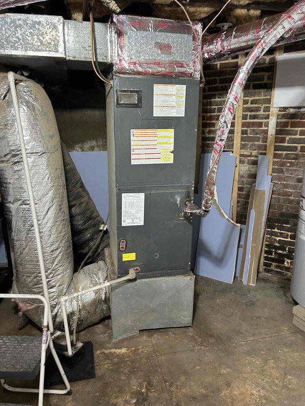 # HVAC Service Report - No Cooling Condition

## System Information
Six-year-old residential air conditioning system experiencing complete loss of cooling capacity.

## Diagnostic Findings
Upon arrival, performed comprehensive system evaluation of the air handler unit located in basement mechanical room. Visual inspection revealed air handler in typical residential installation with proper ductwork connections and insulation in place.

Detailed examination of evaporator coil assembly uncovered significant contamination issues. Coil fins displayed heavy accumulation of dirt, dust, and biological growth including visible mold and mildew throughout the heat exchange surfaces. Contamination was particularly severe in lower sections of the coil, with dark discoloration and greenish-black deposits restricting airflow between fins. The buildup pattern indicated extended operation without maintenance, resulting in substantially reduced heat transfer efficiency and restricted airflow across the