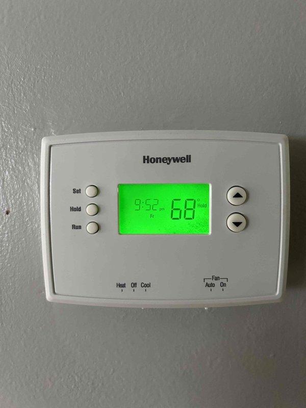 Completed comprehensive AC tune-up on residential split system at vacant property. Performed standard maintenance protocol including filter inspection, refrigerant level check, electrical connection testing, condensate drain line verification, and thermostat operation confirmation. System operating within normal parameters with no deficiencies identified; Honeywell digital thermostat functioning properly and condensate drainage routing observed under air handler.