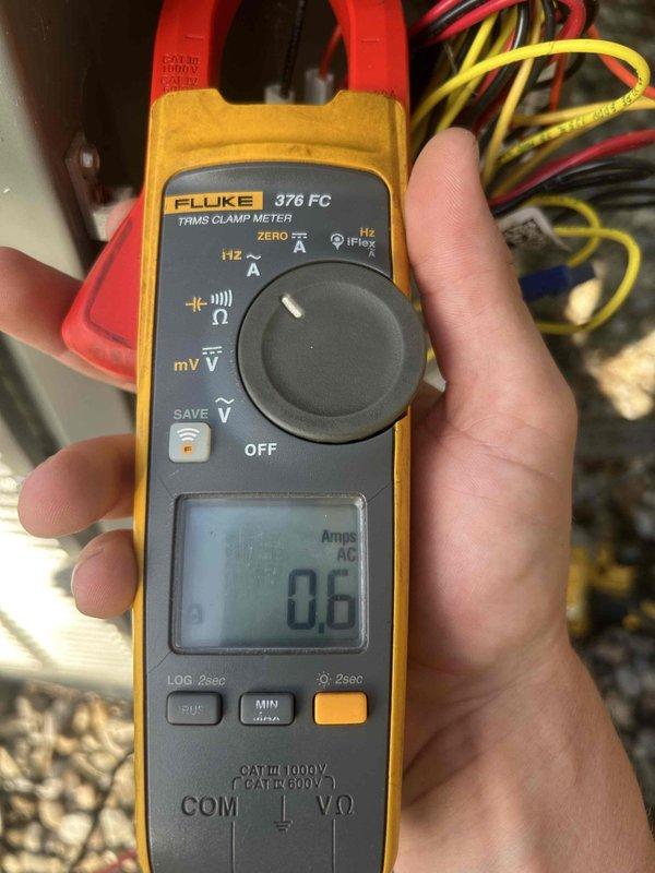 Completed Care Plan maintenance tune-up on gas furnace and air conditioning system located in crawl space. Performed electrical diagnostics using clamp meter, measuring current draw at 0.6 amps AC to verify proper system operation. Inspected equipment condition, noting accumulation of organic debris including leaves and twigs around unit base requiring monitoring for airflow obstruction concerns.