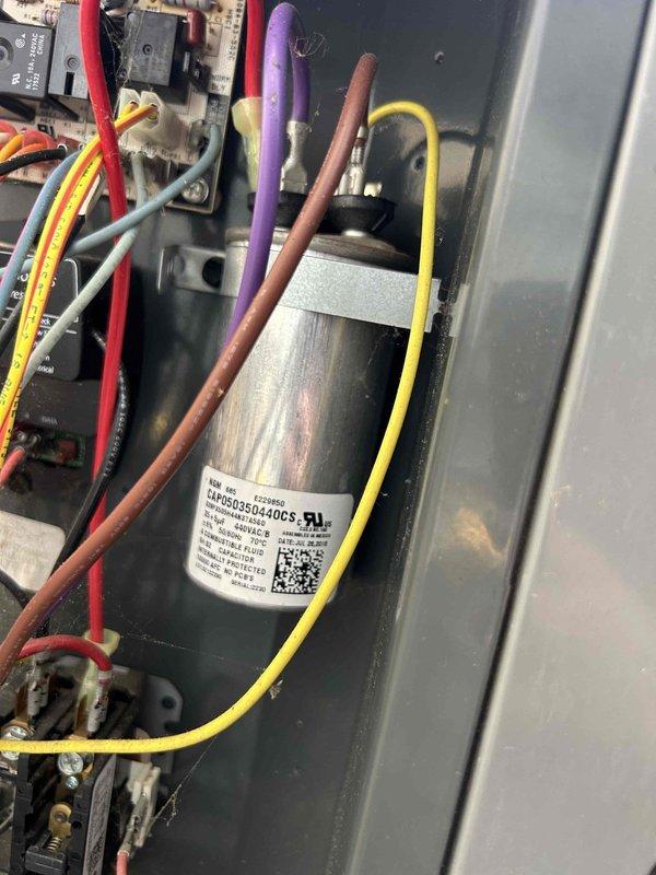 Responded to no-cooling call on 9-year-old heat pump system. Upon arrival, verified compressor would not start and thermostat was calling for cooling. Inspected outdoor unit and found failed dual-run capacitor preventing compressor and condenser fan motor from operating. Replaced defective capacitor with properly-rated unit, restored power, and verified system operation with normal compressor start-up and cooling cycle.