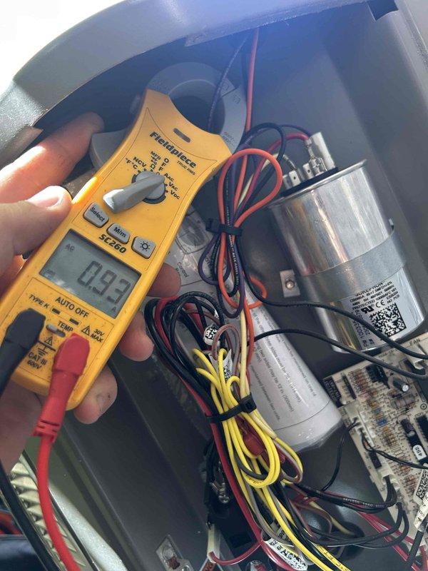 Responded to no cooling complaint on 18-year-old electric HVAC system with indoor unit located upstairs. Upon arrival, performed diagnostic testing of electrical components using clamp meter, measuring amperage draw at 0.93 amps in the condensing unit's electrical compartment. Inspected dual capacitor configuration and associated wiring connections for proper operation. Checked air filter condition at return vent, which appeared clean and unobstructed. System evaluated for age-related component wear and operational efficiency given extended service life beyond typical equipment lifespan.