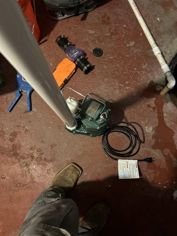 Replaced failed sump pump unit and deteriorated plastic pit cover in 100-year-old residential property. Removed existing pump assembly, installed new submersible sump pump with integrated float switch, and connected discharge piping using PVC fittings. Secured new pit cover to prevent debris accumulation and ensure proper system operation while maintaining accessibility for future maintenance.