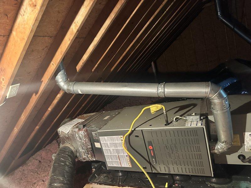 Conducted comprehensive evaluation of two residential HVAC systems for replacement estimate. Inspected 11-year-old and 18-year-old gas furnace systems with heat exchangers located in basement and attic. Assessed attic-mounted air handler unit with associated flexible and rigid ductwork configurations. Documented equipment conditions, age-related wear, and operational status through photographic evidence. Reviewed system specifications and equipment labels to determine current capacities and compatibility requirements for replacement units. Provided replacement options and recommendations for dual-system installation to address immediate heating and cooling needs.