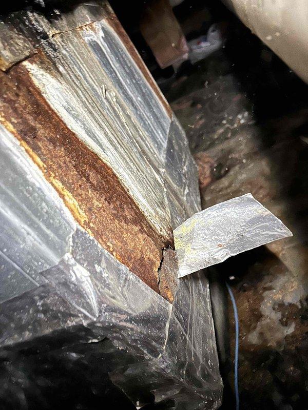 Responded to no cooling complaint for commercial HVAC system serving kitchen, front lobby area, laundry room, and medical office spaces. Upon inspection, discovered evaporator coil with severe rust corrosion and deterioration throughout, along with extensive moisture damage to metal ductwork and plenum assembly. Found multiple holes and weak points in duct sections with heavy rust streaking, mineral deposits indicating prolonged condensation issues, and previous failed tape repair attempts. Coil fins showed advanced degradation with rust buildup compromising heat transfer capability. System failure attributed to combination of age-related deterioration, chronic moisture exposure in installation environment, and high usage patterns from frequent door traffic during cooling season. Documented equipment condition with photos showing extent of corrosion damage to both evaporator coil and surrounding duct components. Recommended complete replacement of indoor air handler unit and associated