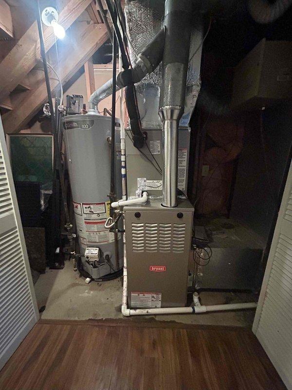 Completed full HVAC system replacement in residential basement utility area. Removed and disposed of existing equipment. Installed new Bryant 70,000 BTU 80% efficiency single-stage gas furnace (model 800SB36070M17) with Bryant 3-ton 14.3 SEER2 single-stage air conditioning system and matching evaporator coil (model WCVAVA3617XMA). 

Installed outdoor condensing unit on new equipment pad with electrical whip kit and disconnect box. Ran and insulated refrigerant lines with filter drier installation. Connected evaporator coil to existing ductwork with proper transitions and installed standard-sized air filter rack. Installed SS2 coil drain safety water sensor for secondary drain pan protection.

Connected furnace to existing flue piping with proper venting. Installed flexible gas line connector with gas shut-off switch and flame roll-out protection for safety compliance. Installed electrical shut-off switch for service accessibility. Upgraded to digital thermostat for improved system cont
