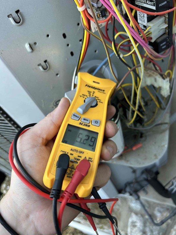 Responded to no cooling complaint on heat pump system located in laundry room. Performed diagnostic testing on air handler unit using infrared thermometer and multimeter to measure supply air temperature and verify electrical component operation. Supply air temperature measured at 65°F, indicating insufficient cooling capacity. Conducted electrical diagnostics at control board, measuring microamp readings at 5.28 to verify proper signal communication between components. Inspected wiring connections, control module, and relay operation within equipment panel. System evaluation completed with diagnostic findings documented for recommended repairs.