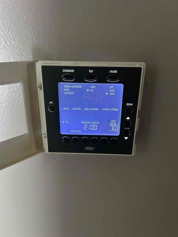 Responded to priority no-cool service call for residential HVAC system with indoor temperature at 84°F. Upon arrival, inspected digital programmable thermostat showing system in temporary hold mode with cooling setpoint at 10°F, indicating potential thermostat programming or configuration issue. Performed diagnostic evaluation of gas furnace and air conditioning system located in basement utility area. Verified proper electrical connections, examined ductwork distribution system, and assessed overall equipment operation to restore cooling functionality for occupants requiring immediate climate control due to health considerations.