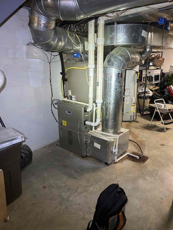 Responded to priority no-cool service call for residential HVAC system with indoor temperature at 84°F. Upon arrival, inspected digital programmable thermostat showing system in temporary hold mode with cooling setpoint at 10°F, indicating potential thermostat programming or configuration issue. Performed diagnostic evaluation of gas furnace and air conditioning system located in basement utility area. Verified proper electrical connections, examined ductwork distribution system, and assessed overall equipment operation to restore cooling functionality for occupants requiring immediate climate control due to health considerations.
