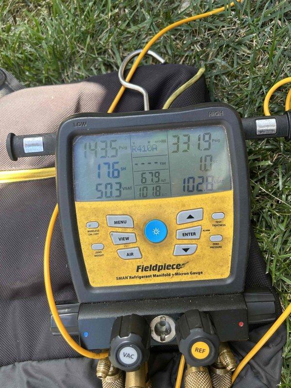 Responded to callback for upstairs unit not maintaining setpoint after recent part replacement. Upon arrival, system was set to 72°F but struggling to reach desired temperature. Connected refrigerant manifold and micron gauge to evaluate system performance and refrigerant charge. Measured operating pressures and superheat readings on both low and high sides of the system. Low side readings indicated 19.12 psig with 15.5°F superheat, while high side showed elevated discharge temperatures of 273.6°F. Performed comprehensive system diagnostics to verify proper refrigerant charge levels and identify any issues affecting cooling capacity. Checked all connections from previous service work to ensure integrity. System performance parameters brought within acceptable operating range. Unit now cooling properly and maintaining desired temperature setpoint.