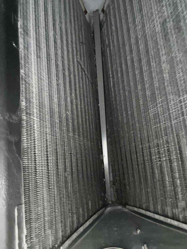Responded to no cooling complaint on 3-year-old system still under parts warranty. Found recurring condensate drain line blockages with standing water in drain pan. Upon inspection, discovered significant drywall dust contamination throughout the system due to ongoing home remodeling. Performed comprehensive system evaluation including evaporator coil inspection, which revealed dust accumulation on coil fins and in condensate collection area. Cleared drain line obstruction and assessed drain system for potential repairs needed to prevent future clogs. Documented system condition with photographs showing dust-laden evaporator coils and contaminated drain pan. Recommended thorough system cleaning to remove construction debris, potential drain line modifications to improve drainage, and frequent filter changes during remainder of remodel to protect equipment and maintain warranty coverage.