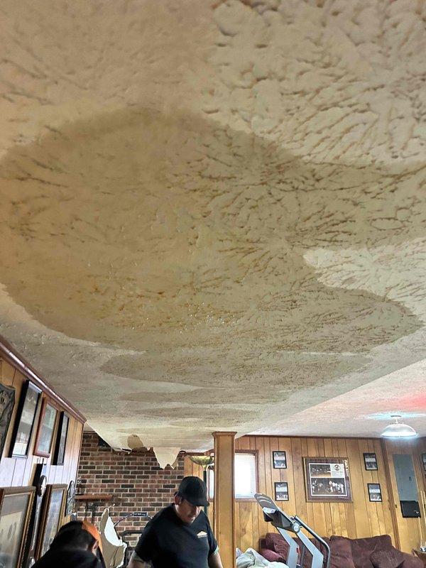 Responded to water leak call for HVAC indoor unit located in basement ceiling. Upon arrival, performed visual inspection of the basement area and ceiling where spray foam insulation is present. Assessed thermostat operation and system status. Documented conditions with photos for service records.