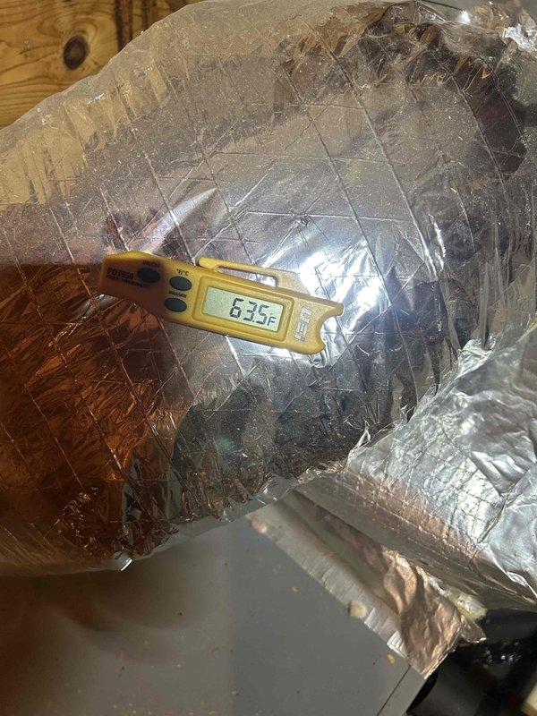 Responded to no cooling complaint on 8-year-old residential air conditioning system with gas furnace. Customer reported intermittent operation where system would run briefly before shutting down and requiring manual reset after extended wait period. Located air handler unit in attic space with flexible ductwork installation.

Performed diagnostic evaluation of system components and operational cycle. Measured supply air temperature at ductwork registering 63.5°F, indicating inadequate cooling performance. Inspected air handler, refrigerant lines, and ductwork connections in attic installation area. Observed copper refrigerant line routing and duct insulation condition. Evaluated system for potential causes of short cycling including airflow restrictions, refrigerant charge issues, safety limit switches, and control board functionality.

Documented system conditions with temperature readings and visual inspection of installed components. Verified proper duct insulation and connection in