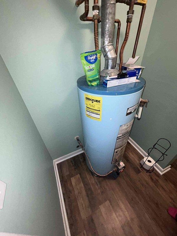 Conducted comprehensive plumbing assessment addressing multiple concerns including upstairs bathroom sink low water pressure diagnostics, laundry room washer drain evaluation for potential clogs or leaks, and crawl space inspection to identify piping material and assess for lead pipe presence. Inspected existing gas water heater installation, documented current unit condition with copper supply line connections and corrugated flex connectors, and provided estimates for both conventional tank-style and tankless gas water heater replacement options.